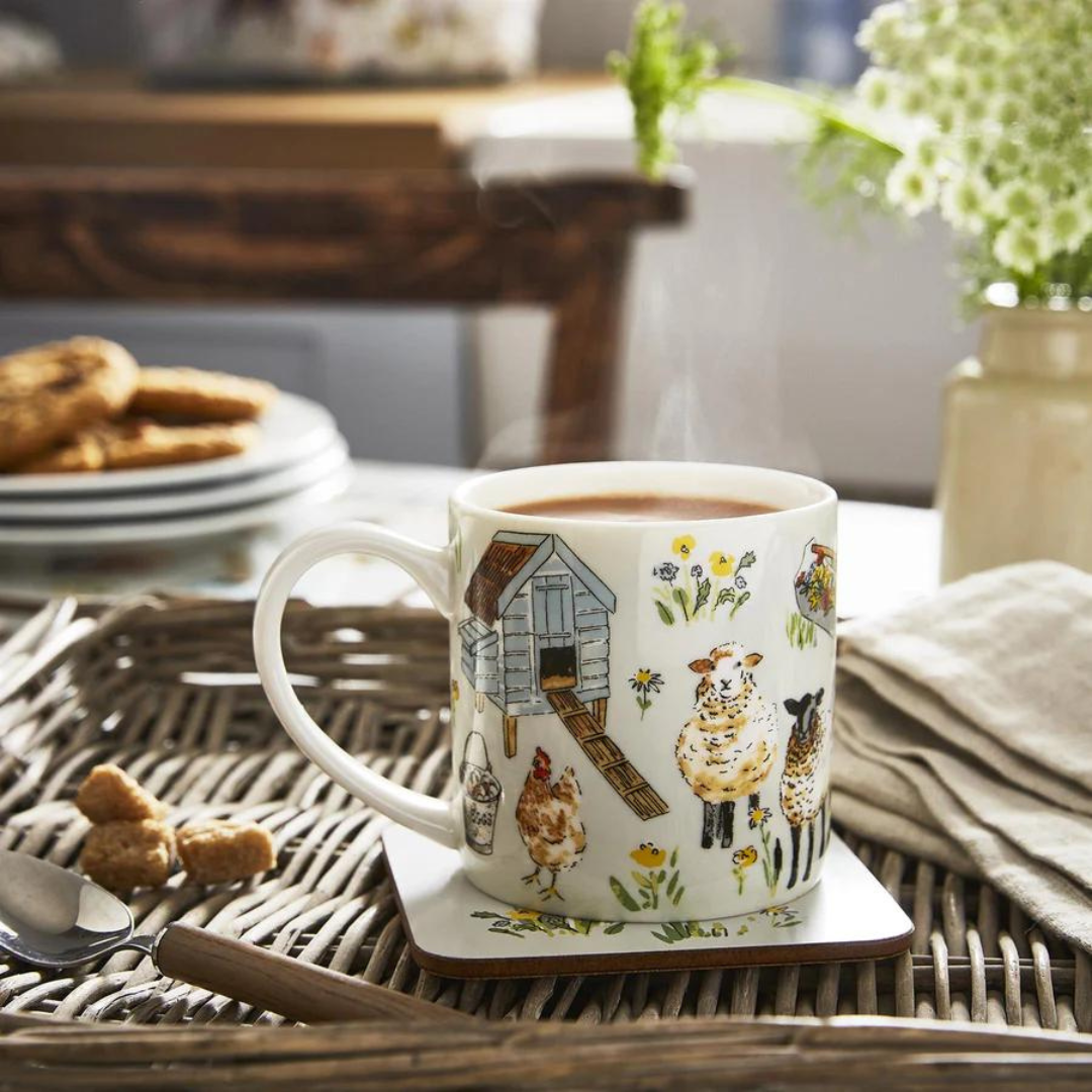 Steaming hot drink in a mug with farm animal illustrations on a wicker tray