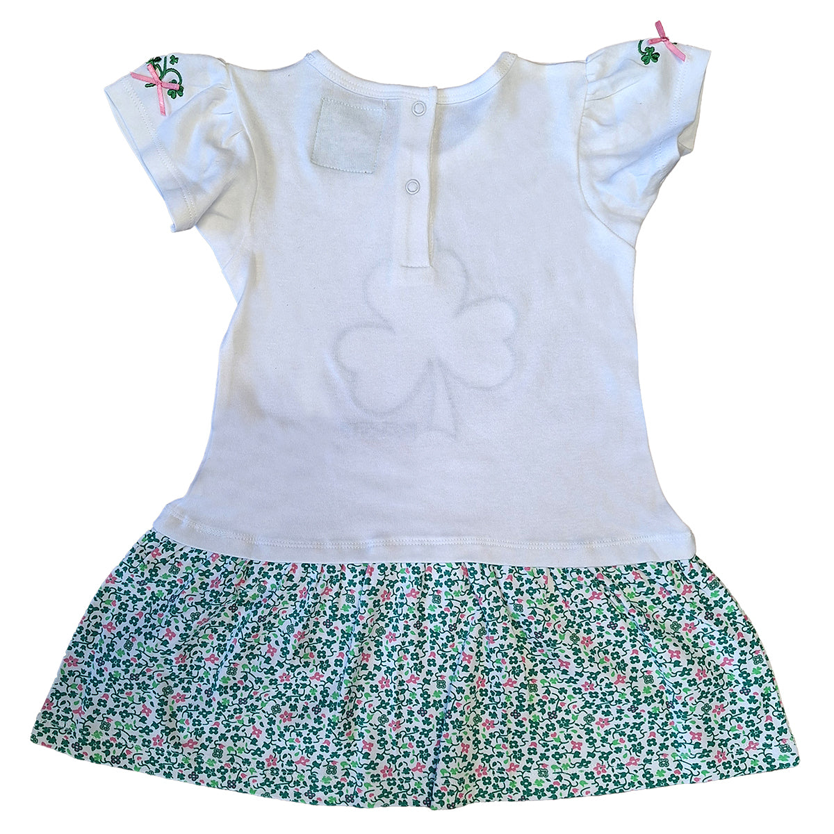 White kids dress with a floral green shamrock print skirt and pink ribbon details on the short sleeves