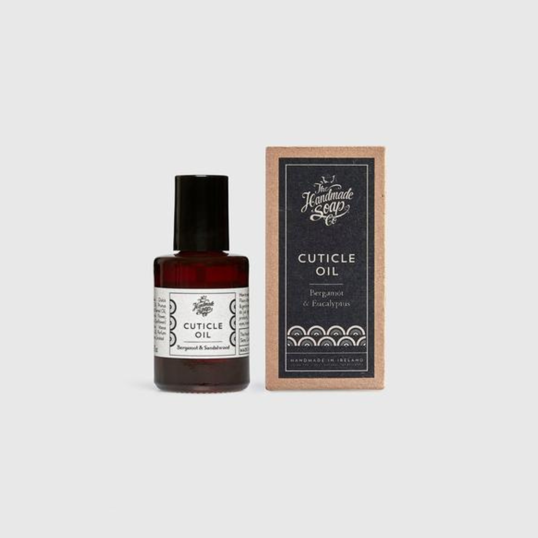 Small brown bottle of cuticle oil next to its rectangular cardboard box