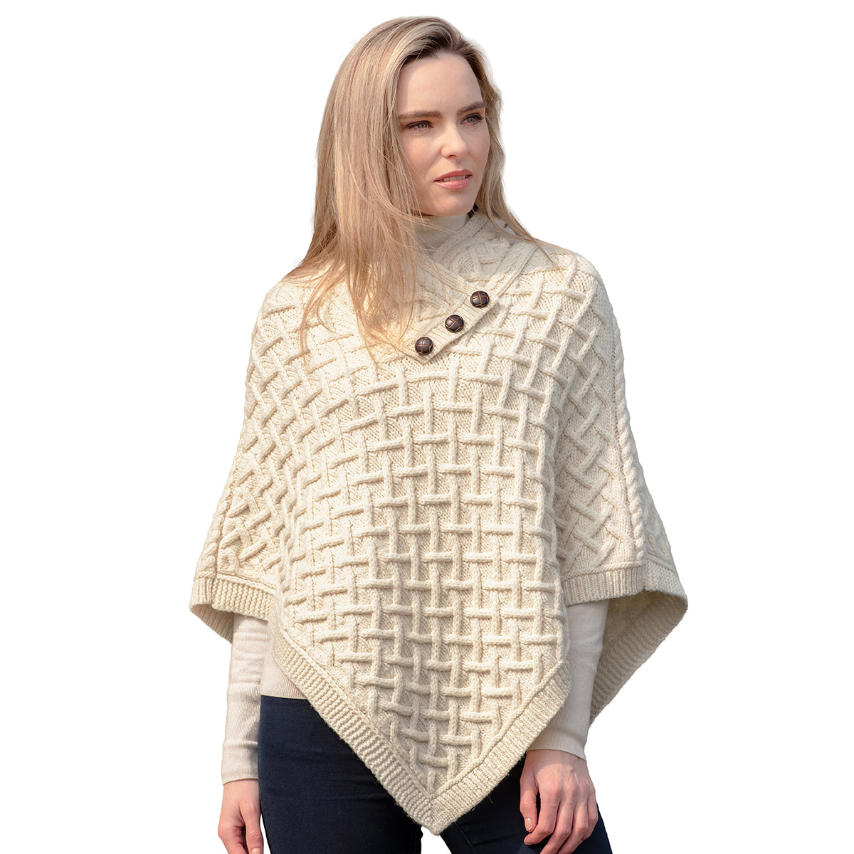 Cream merino poncho with an intricate lattice knit draped on a model.