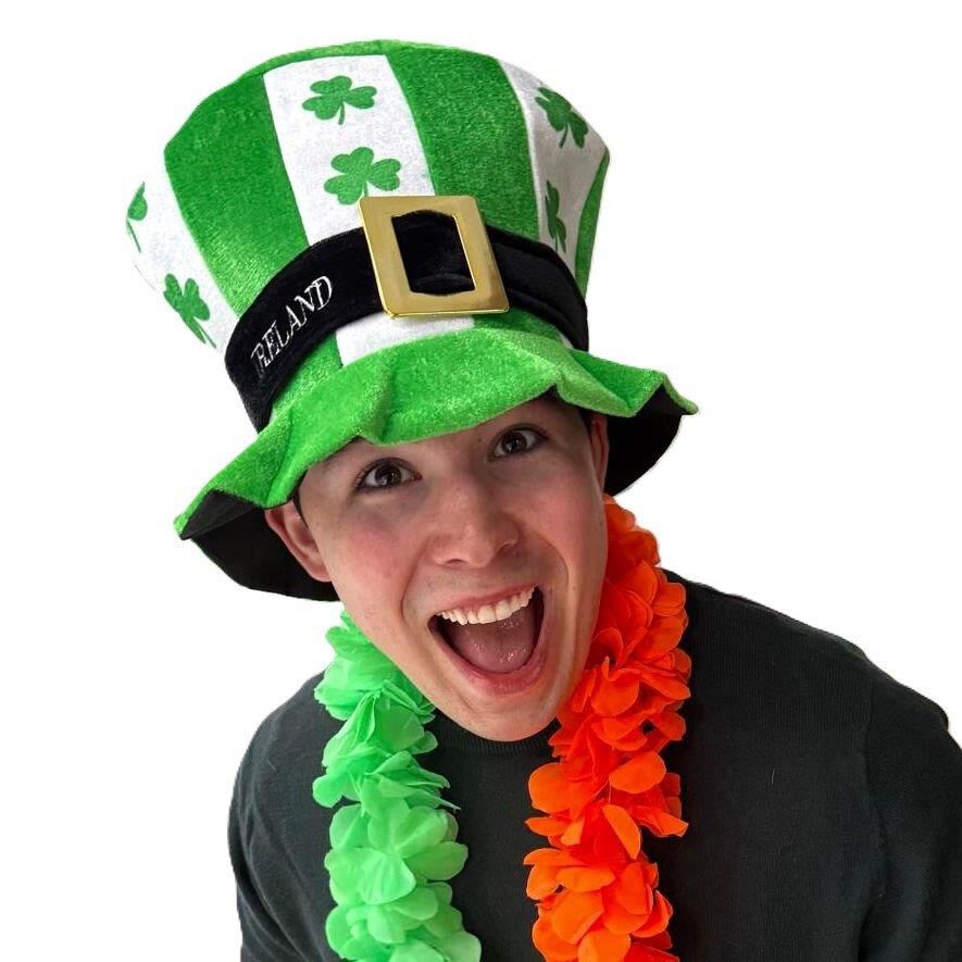 Smiling person wearing a green and white shamrock hat and colorful leis