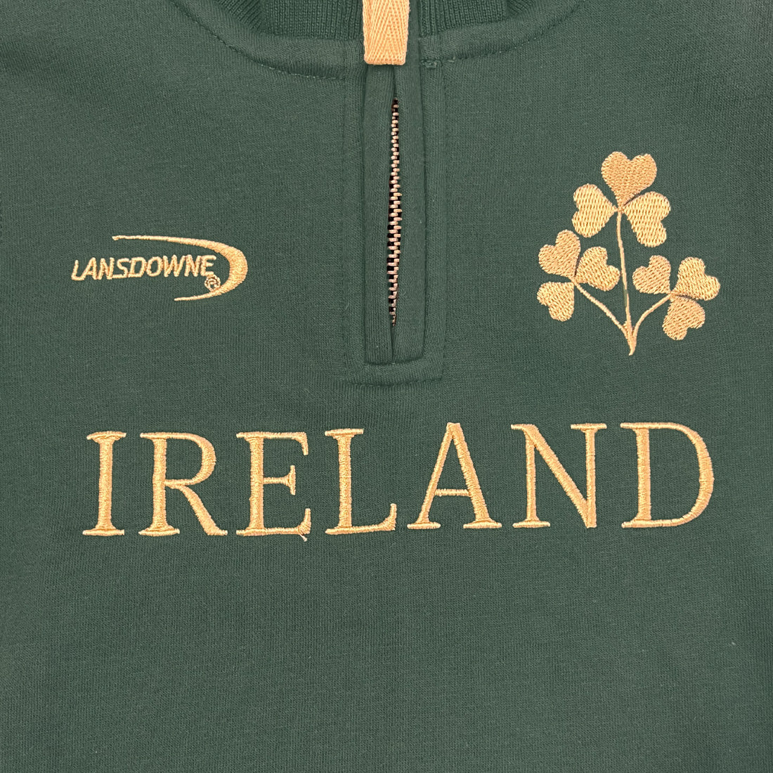 Green fabric with gold embroidery of shamrocks and Ireland text