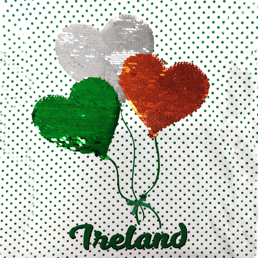 Three heart-shaped balloons in green, white, and orange with Ireland text