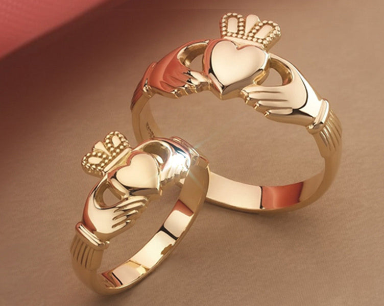 Two gold claddagh rings 