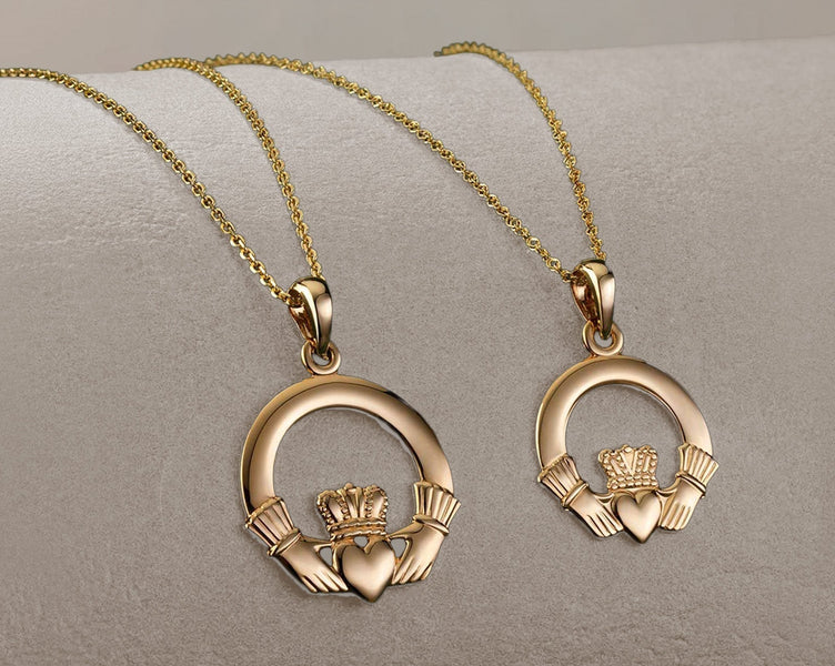 Two gold claddagh necklaces