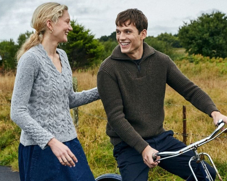 Two people walking wearing aran sweaters