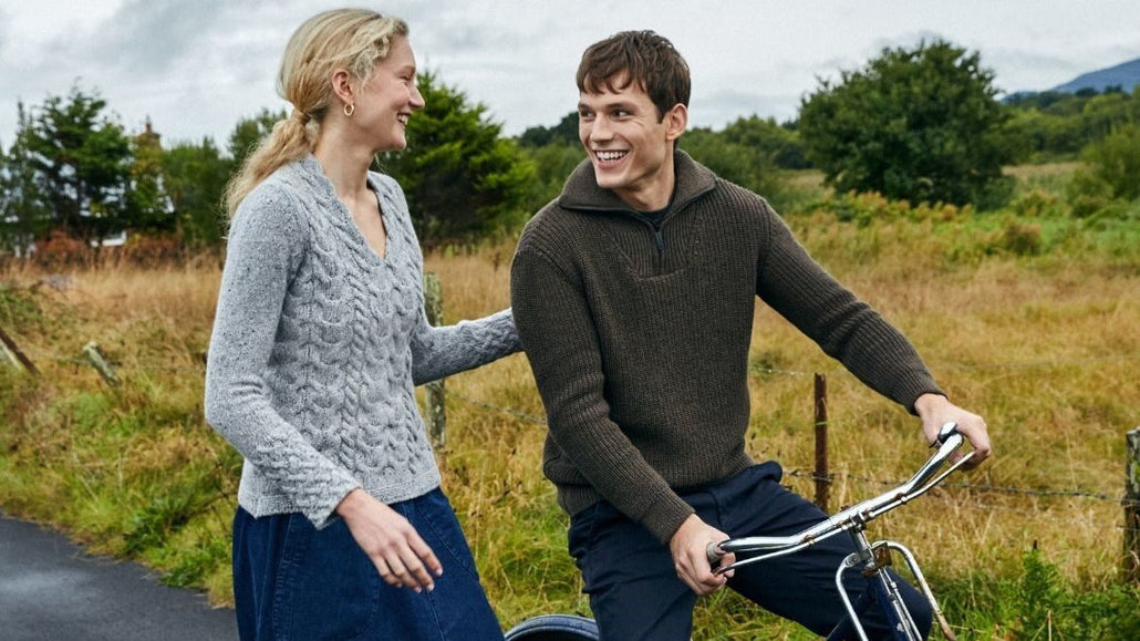 Two people walking wearing aran sweaters