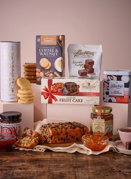 Assorted festive treats including mince pies, biscuits, marmalade, and tea with decorations