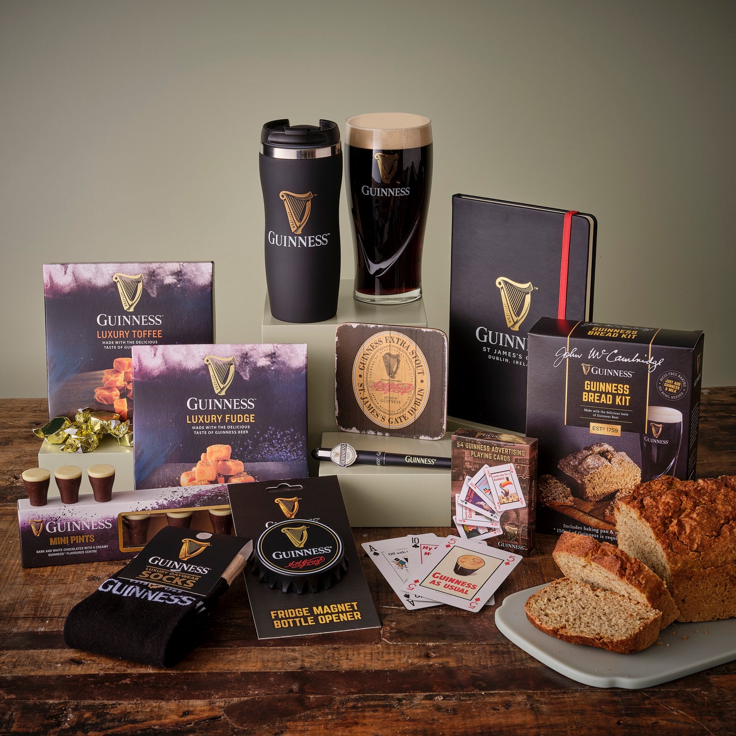 Assortment of Guinness branded products including snacks, socks, and a pint glass
