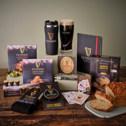 Assortment of Guinness branded products including snacks, socks, and a pint glass