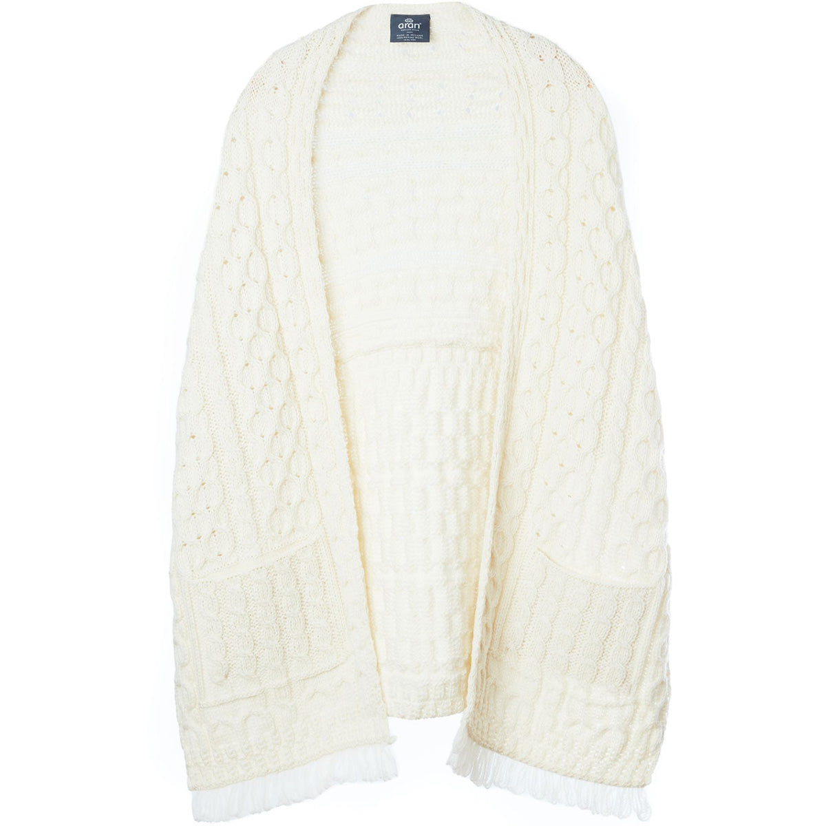 Cream Shannon Merino Aran wrap laid flat showing textured knit and fringe edges.