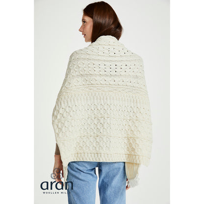 Back view of a woman wearing the Shannon Throwover Merino Aran Cream Wrap over a brown sweater