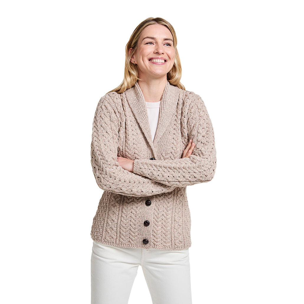 Beige shawl collar Merino Aran cardigan with buttons worn by a smiling woman