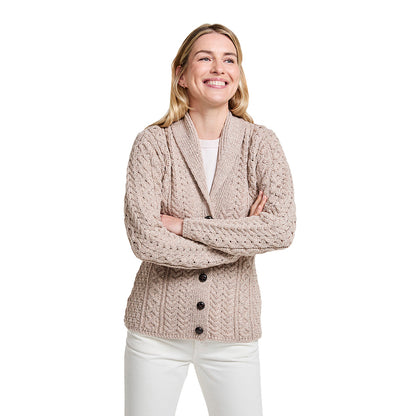 Beige shawl collar Merino Aran cardigan with buttons worn by a smiling woman