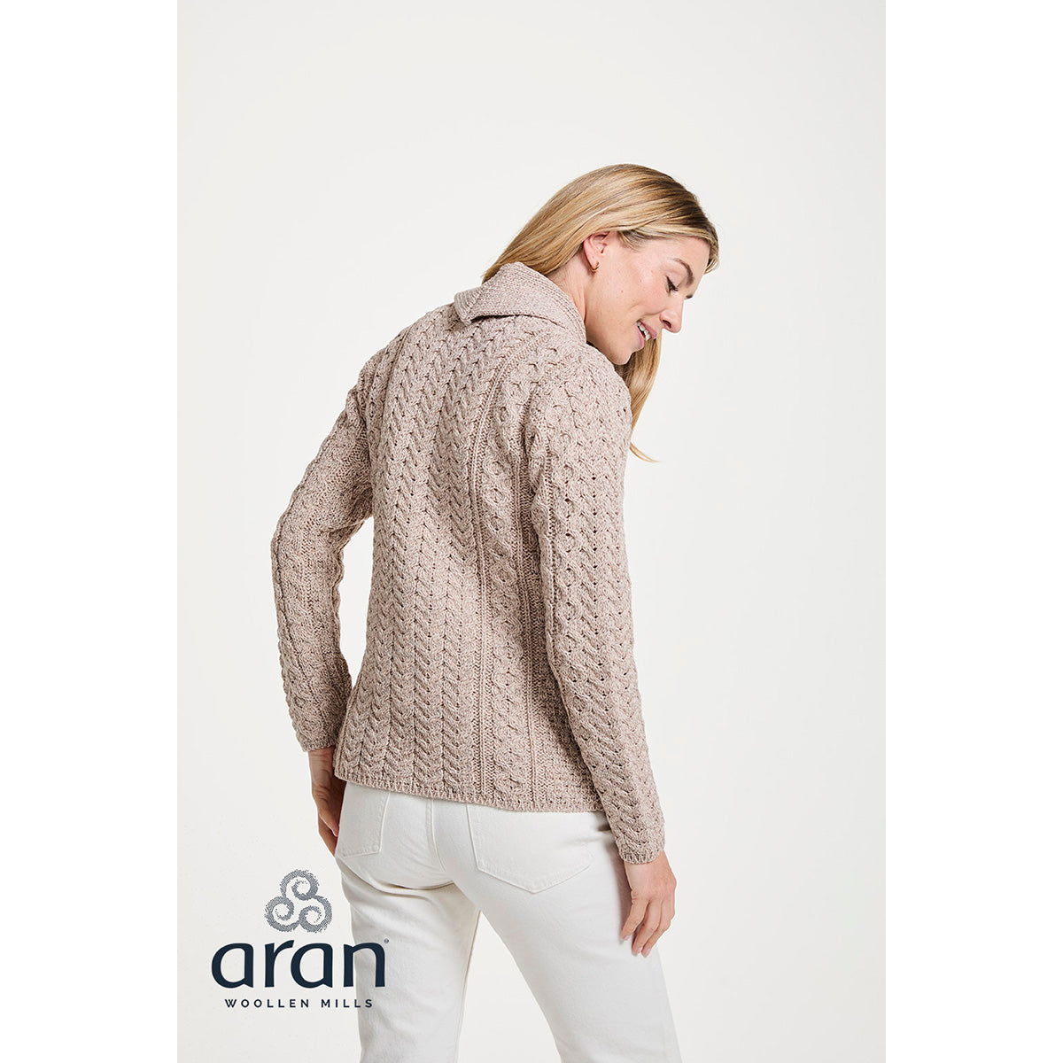 Back view of beige Merino Aran cardigan with a textured knit and shawl collar.