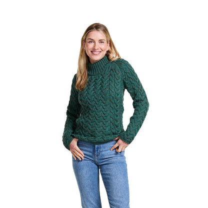 Smiling woman in a dark green Knightstown merino aran crew sweater