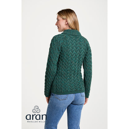 Back view of a model wearing the Knightstown Merino Aran Crew Green Sweater in teal