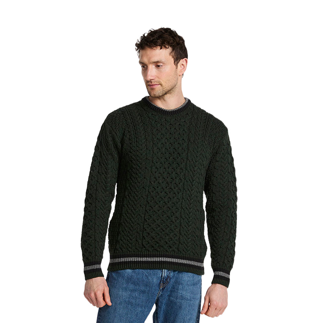 Male model wearing dark green Inishbeg Stripe Crewneck Merino Aran sweater
