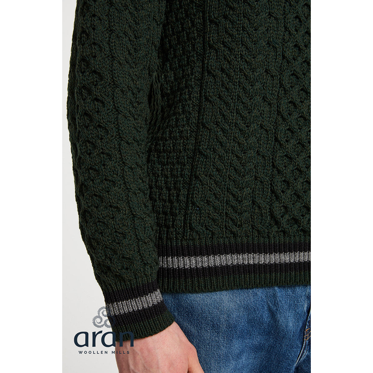 Dark green Merino Aran sweater with cable knit texture and striped ribbed hem and cuffs.