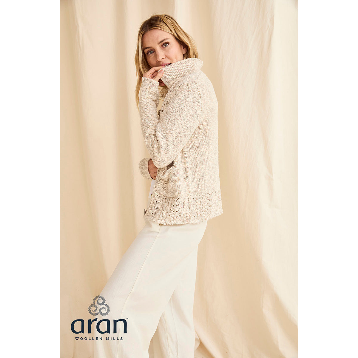 Back view of cream knit cardigan with chunky texture and decorative crochet hem