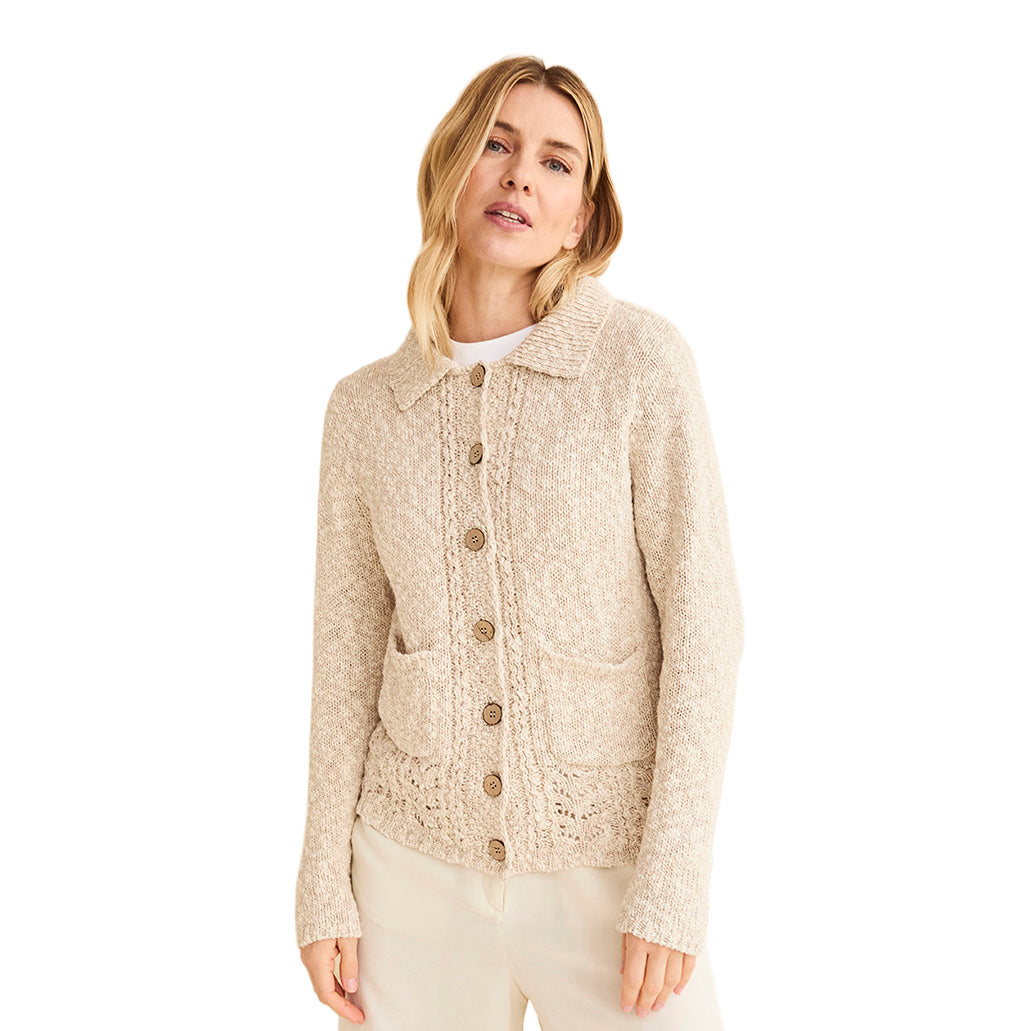 Model wearing cream knitted cardigan with wooden buttons and front pockets
