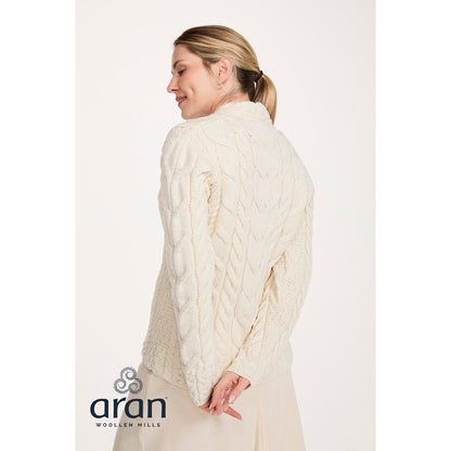 Back view of cream Tralee V-Neck merino sweater with cable knit on a model