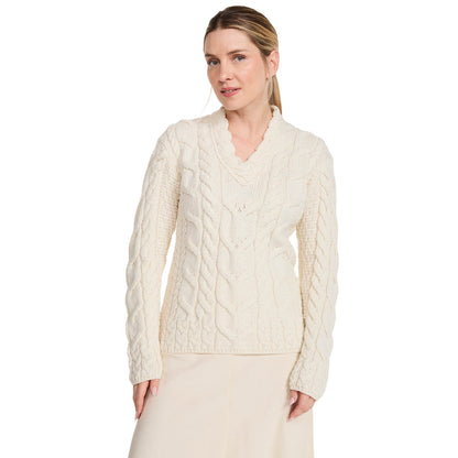 Cream Tralee V-Neck Merino sweater with chunky cable knit on a model