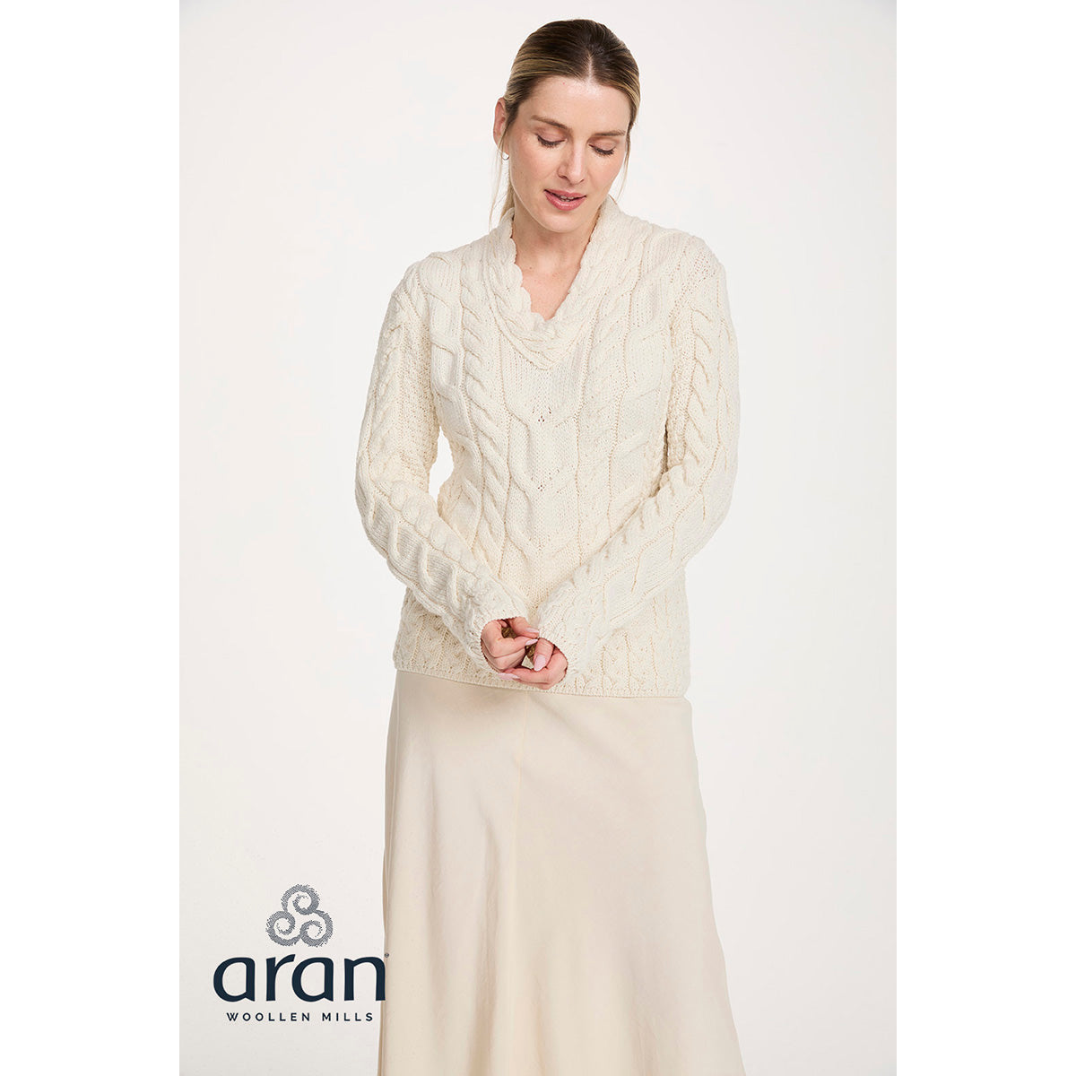 Cream Tralee V-Neck merino sweater with cable knit worn by a model