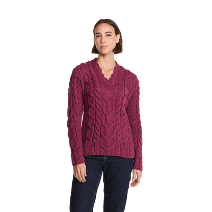 Rich berry Tralee V-Neck merino sweater with cable knit worn by a model