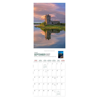 Dunguaire Castle on a grassy promontory with its reflection in the calm water County Galway