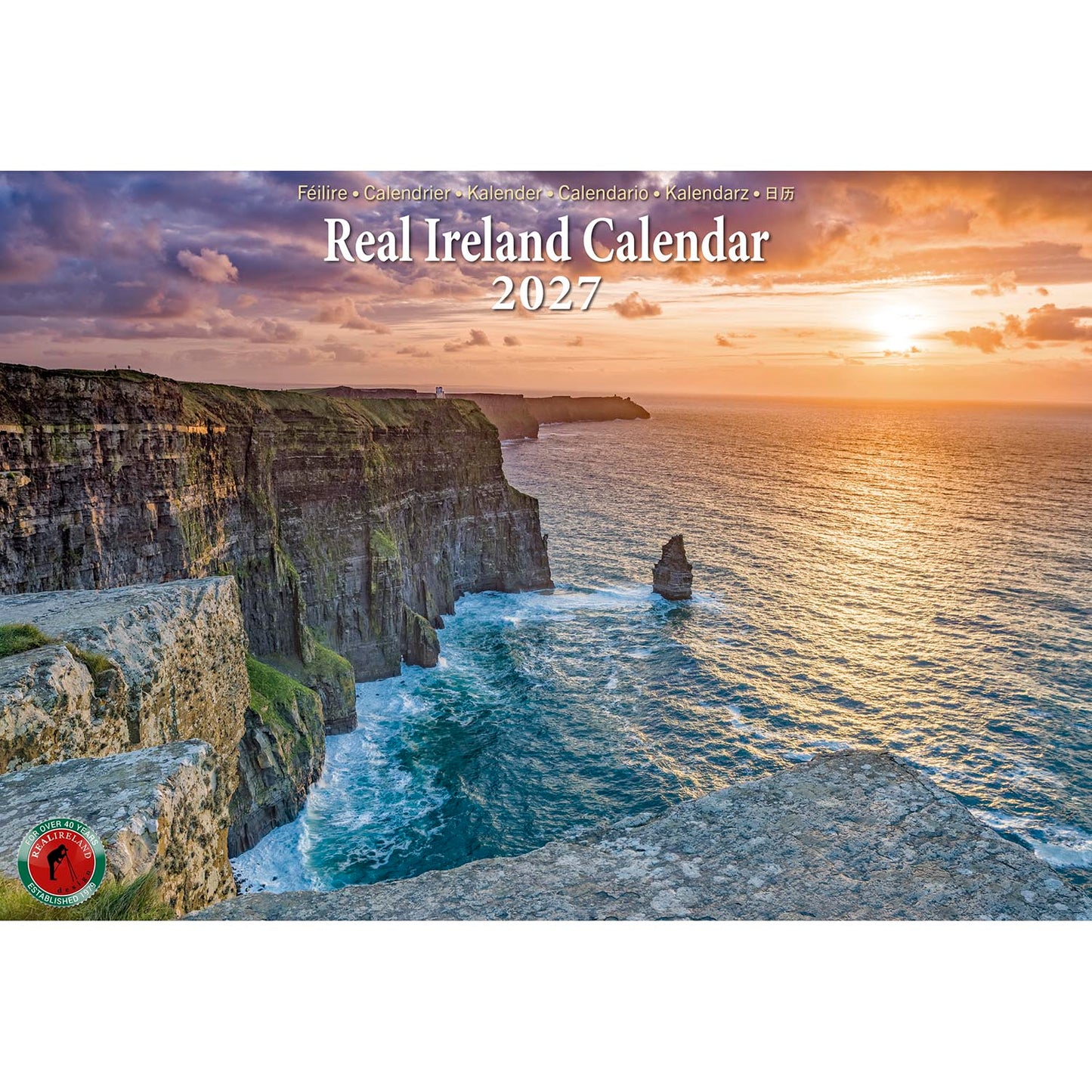 Real Ireland Calendar 2027 cover with a sunset over rugged coastal cliffs and a small logo bottom left