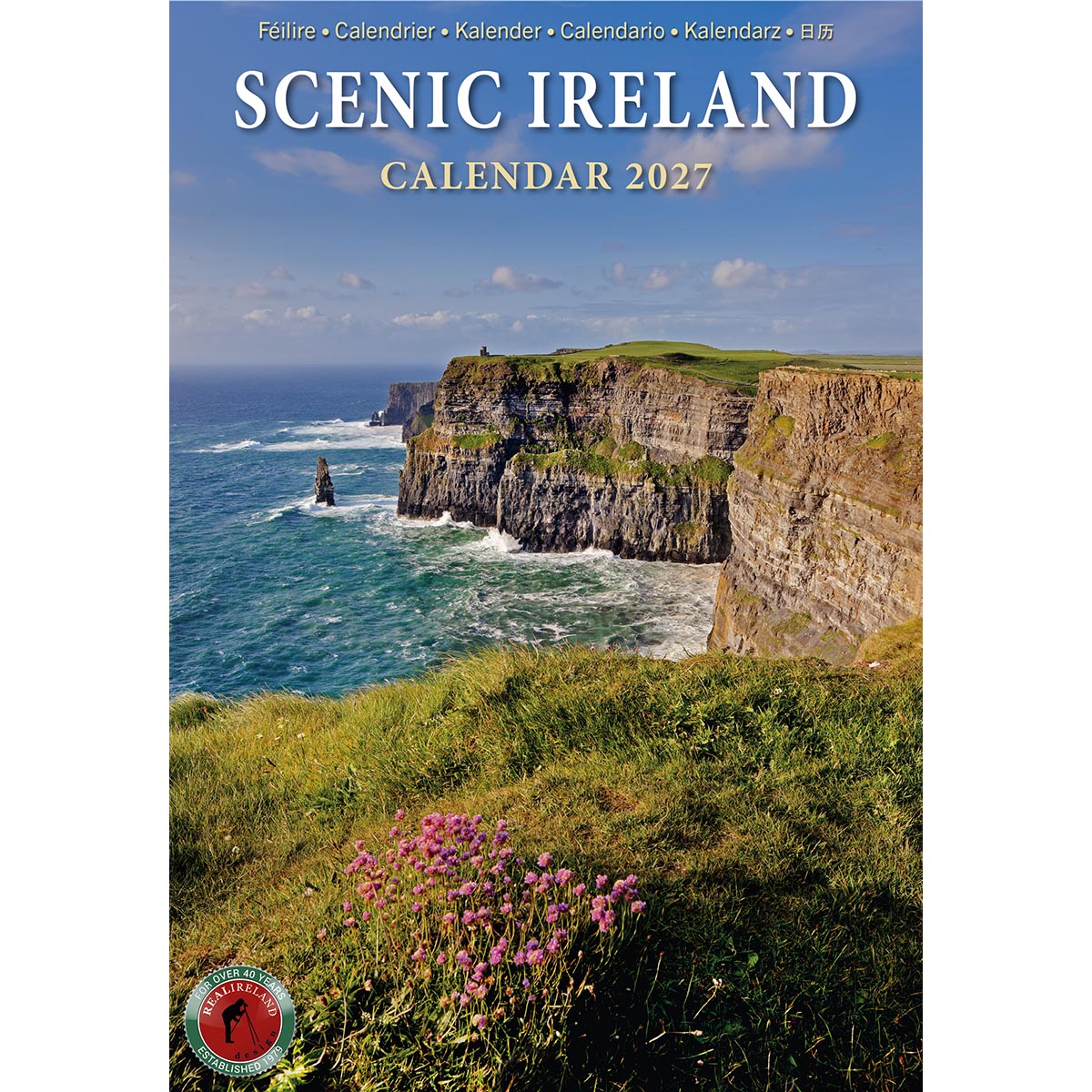 Scenic Ireland calendar 2027 cover featuring rugged coastal cliffs, blue sea, and green foreground with pink flowers