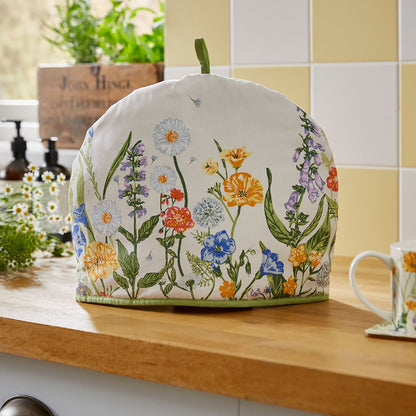 Cottage Garden Tea Cosy on a kitchen counter with the floral print and green trim along the base.