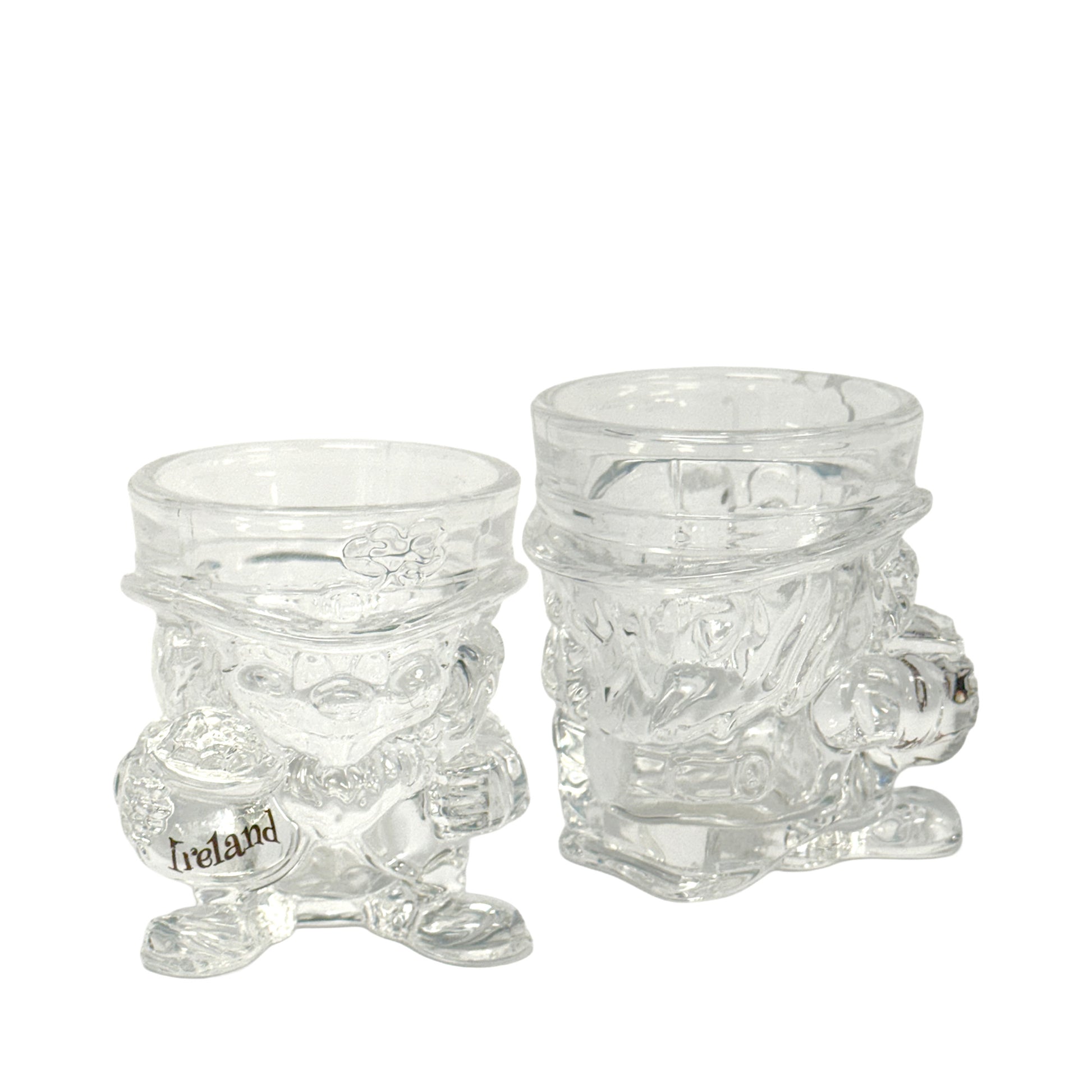 Two clear glass leprechaun shot glasses, one with an Ireland decal