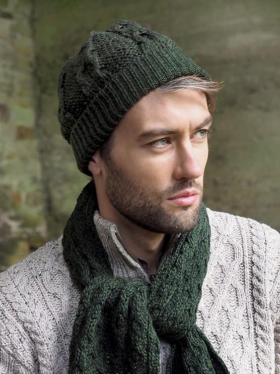 Man wearing a knitted green hat and scarf with a beige sweater