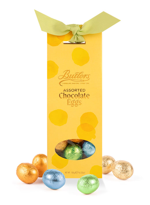 Butlers assorted chocolate eggs in a yellow tapered box with a pale green ribbon and foil-wrapped eggs around