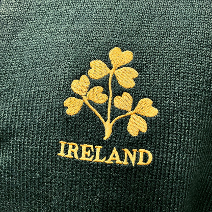 Gold Ireland shamrock embroidery on dark green knit fabric.