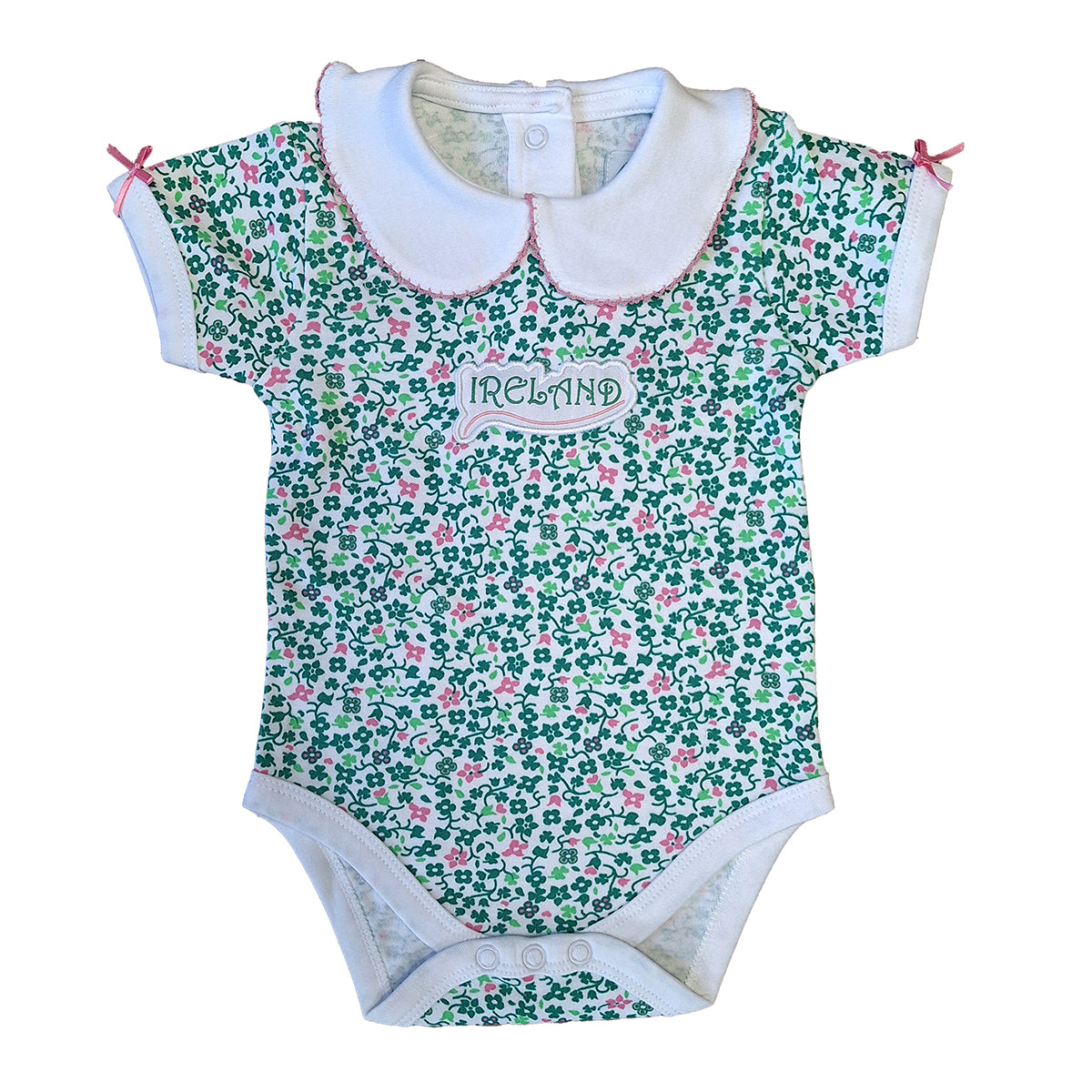 White baby vest with an allover green floral shamrock print and a white collar with pink trim.