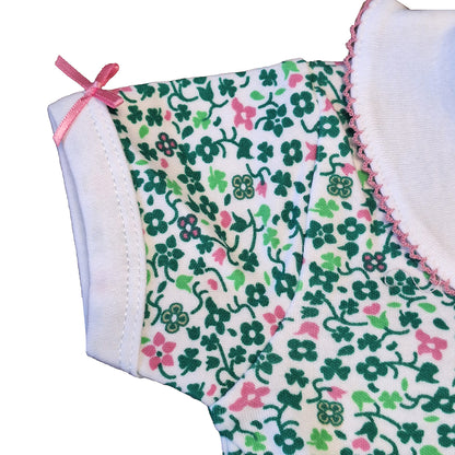 White baby vest with an allover shamrock floral print and a pink shoulder bow
