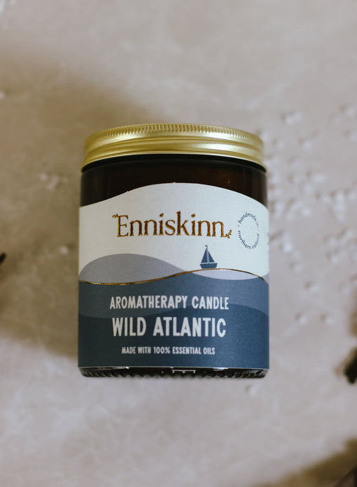 Brown jar with gold lid labeled aromatherapy candle Wild Atlantic