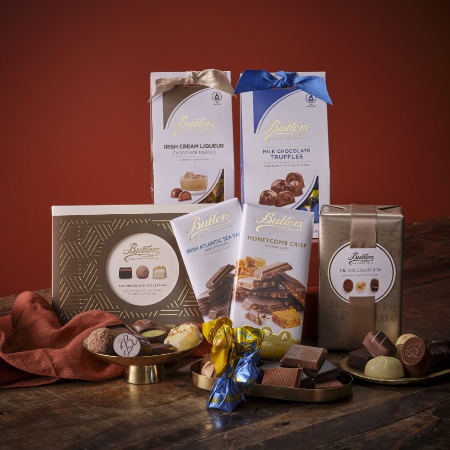 Assorted chocolates, truffles, fudge, and chocolate bars with festive ribbons