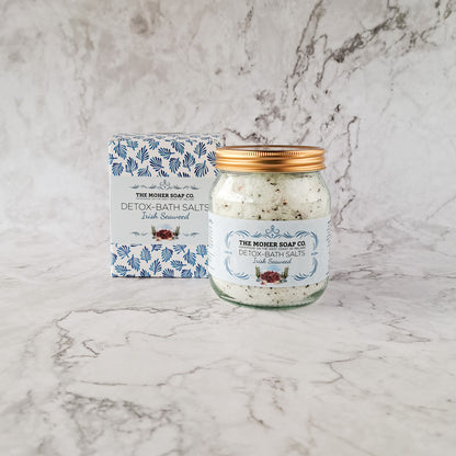 Jar of Detox Bath Salts Irish Seaweed beside a blue patterned box on a marble surface