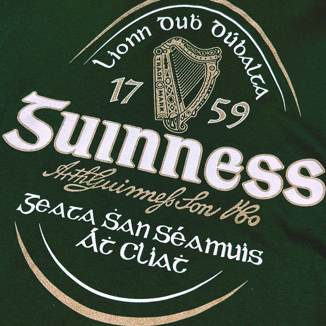Close-up of a green fabric with Guinness logo and harp emblem