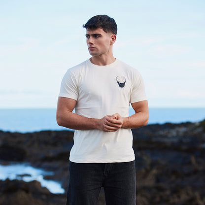 Front view of a man wearing a white Guinness Smiling Pint T shirt with a small pint graphic on the chest.