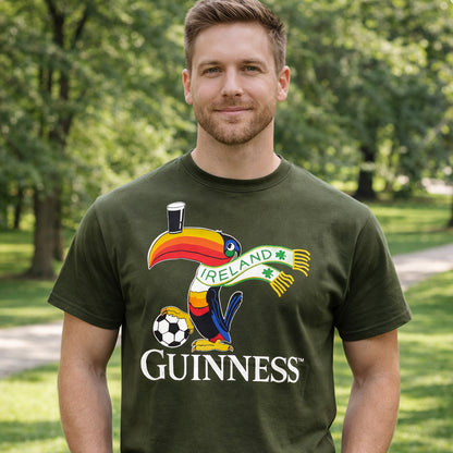 Man wearing a bottle green Guinness Football Toucan T-Shirt outdoors with a colorful toucan graphic.