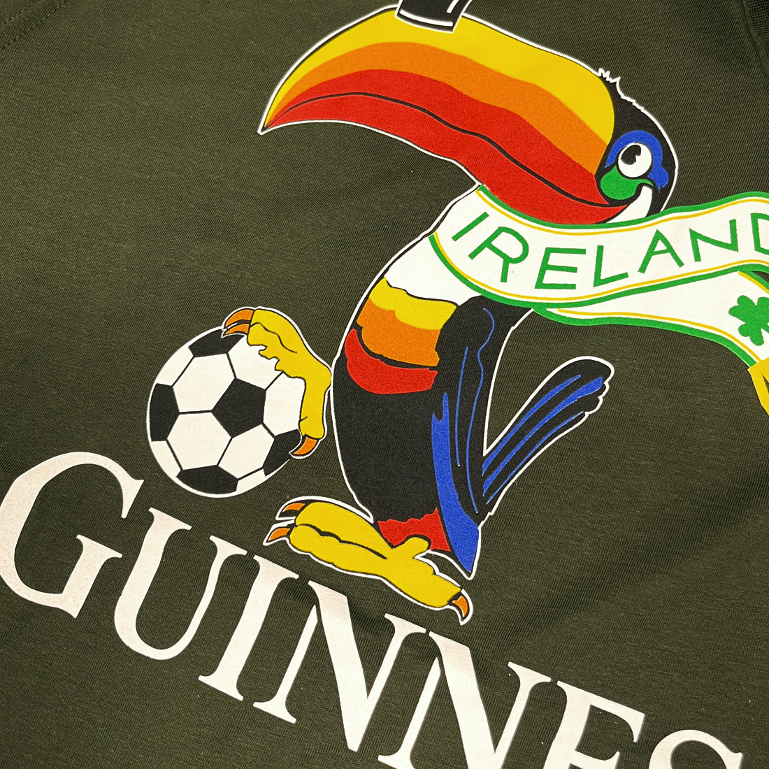 Close-up of the colorful toucan graphic and Ireland banner on the Guinness Football Toucan T-Shirt.