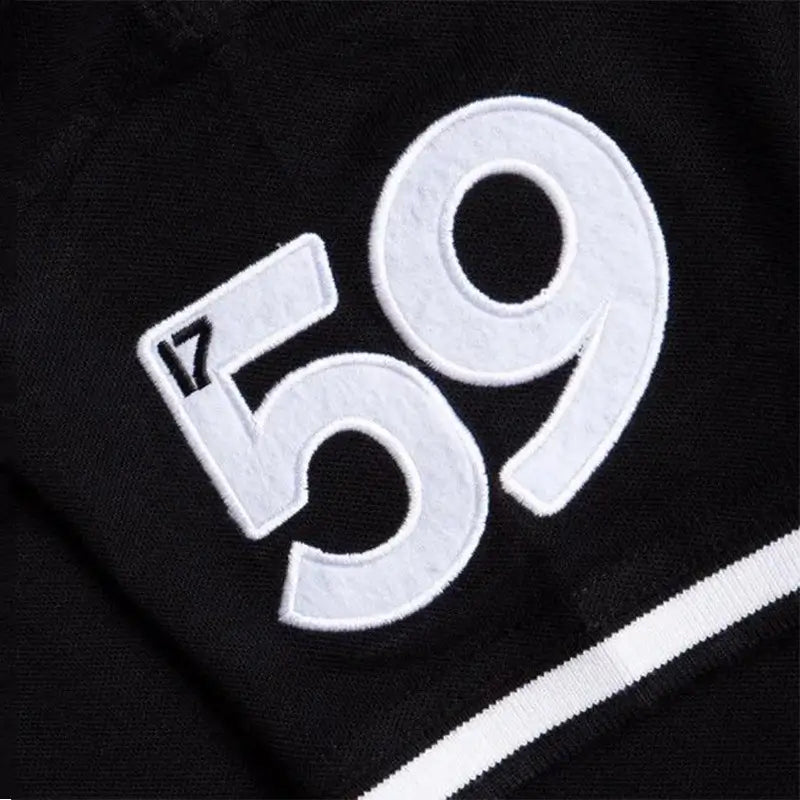 Close up of a white embroidered 59 patch on black Guinness men's polo shirt fabric