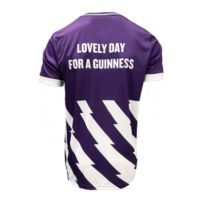 Back view of purple Guinness football top with white text Lovely Day For A Guinness and diagonal white chevrons.