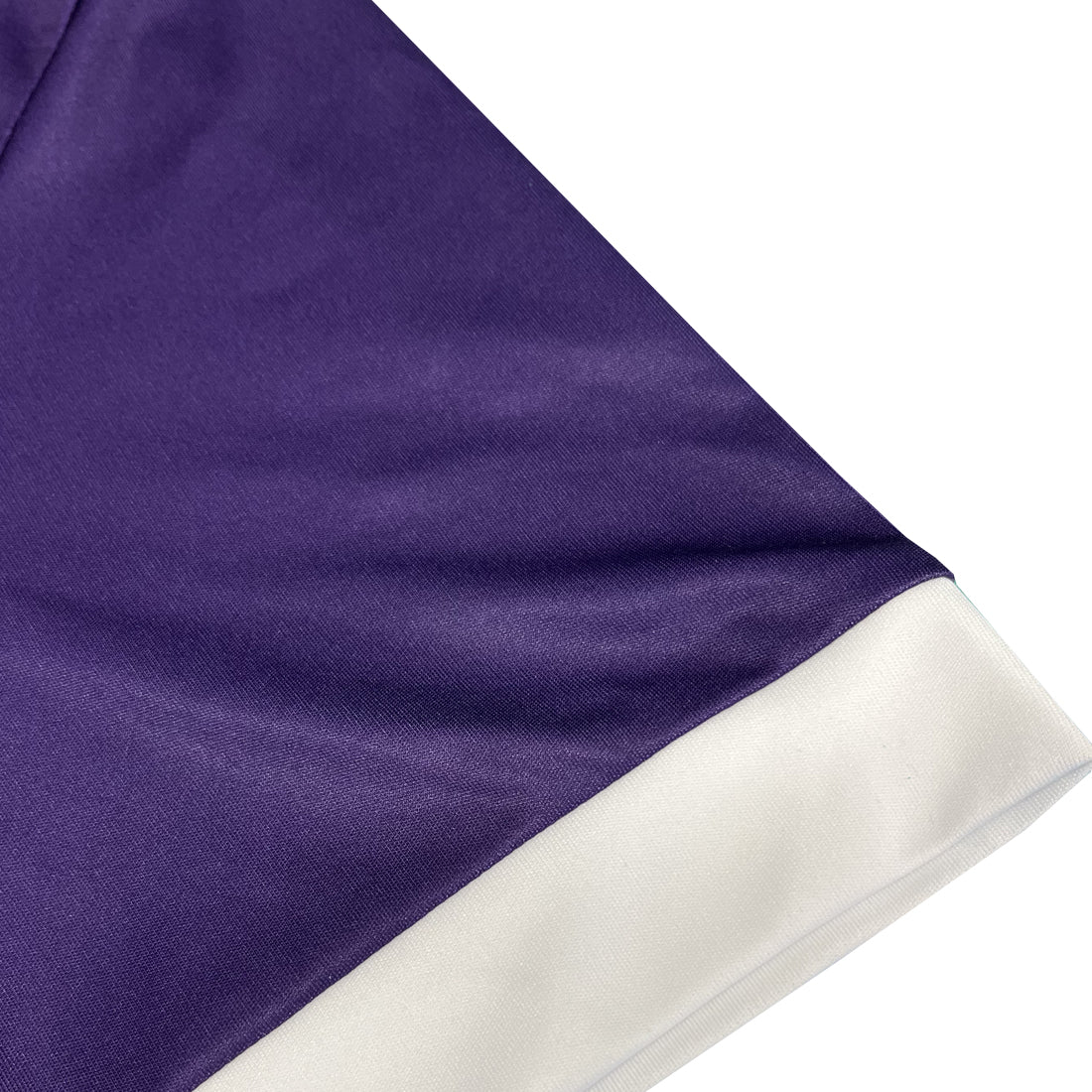 Close-up of purple jersey with white hem along the sleeve.