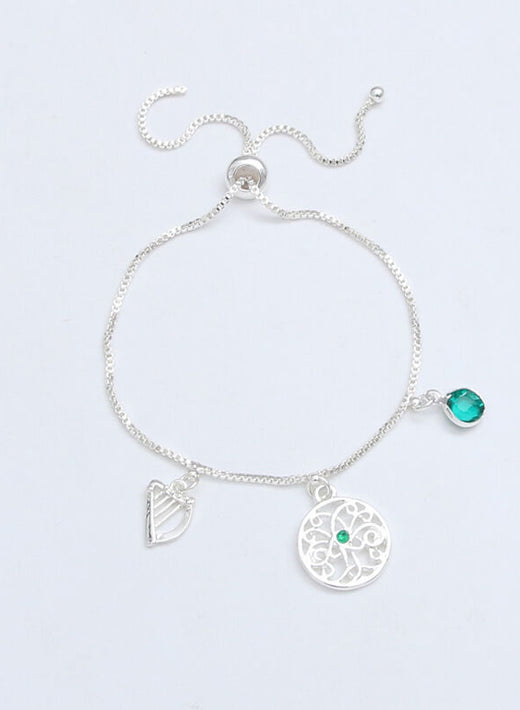 Silver charm bracelet with green gemstone and intricate circular pendant